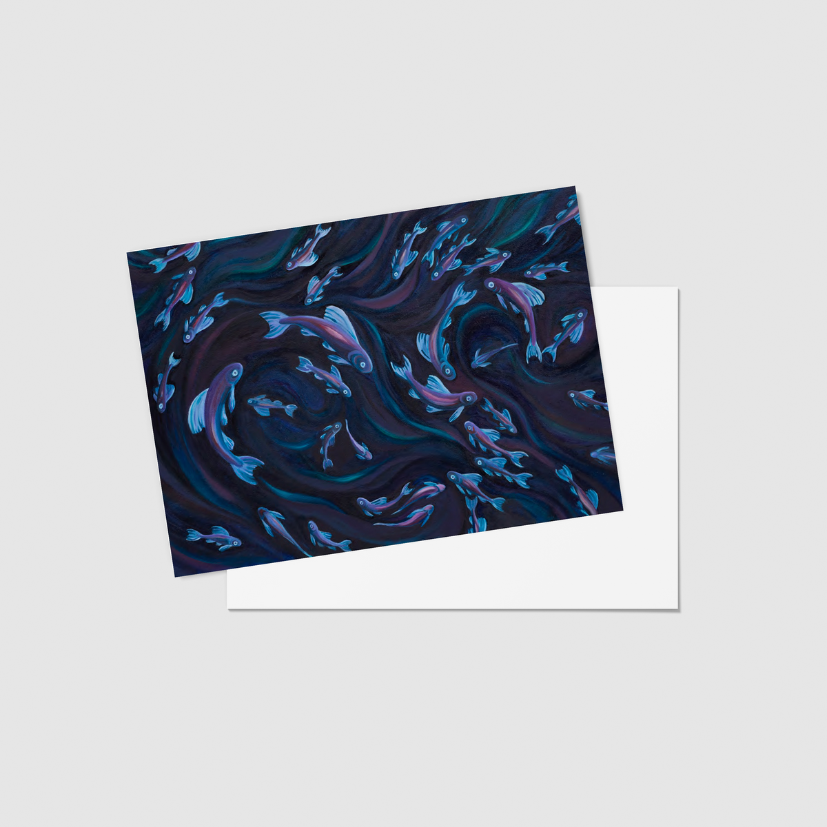 A rectangular art print or card featuring an abstract swirling pattern in deep navy, black, teal, and lavender-blue, shown at an angle over a plain white sheet on a light gray background.
